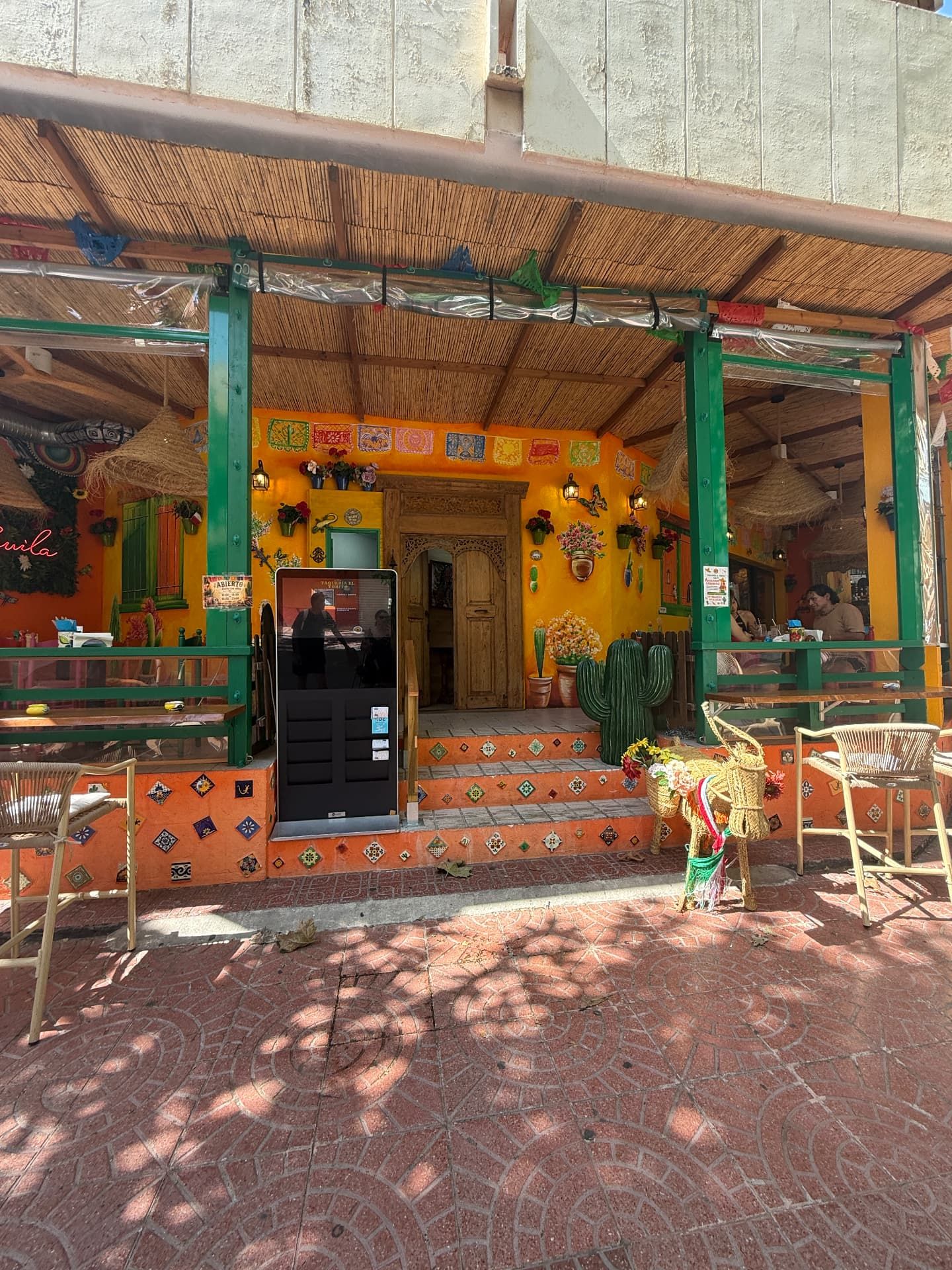 The bright orange and green terrace of Taqueria El Torito, a Mexican restaurant in Calpe