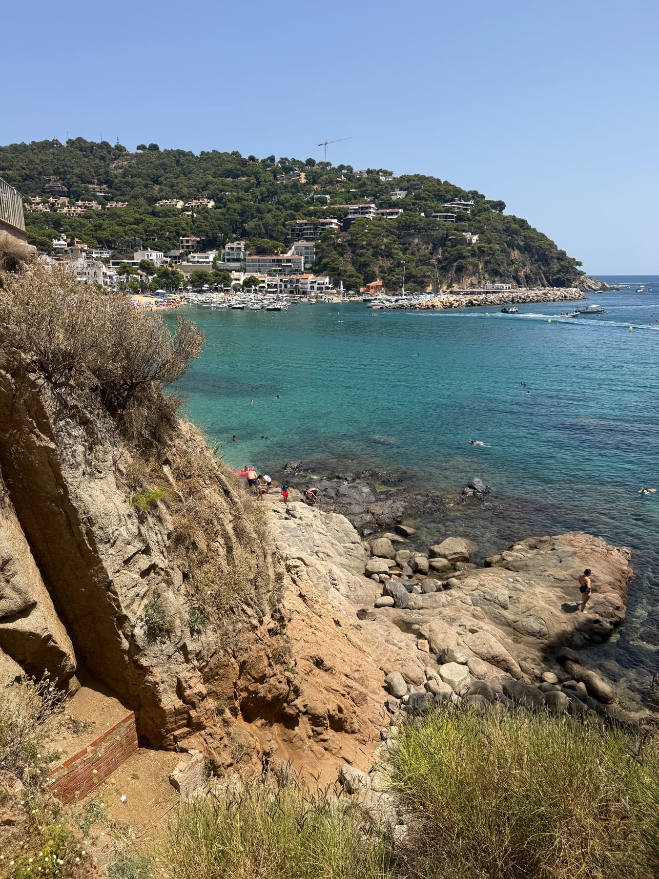 The turquoise bay and rocky shore at Llafranc seen from the Camí de Ronda