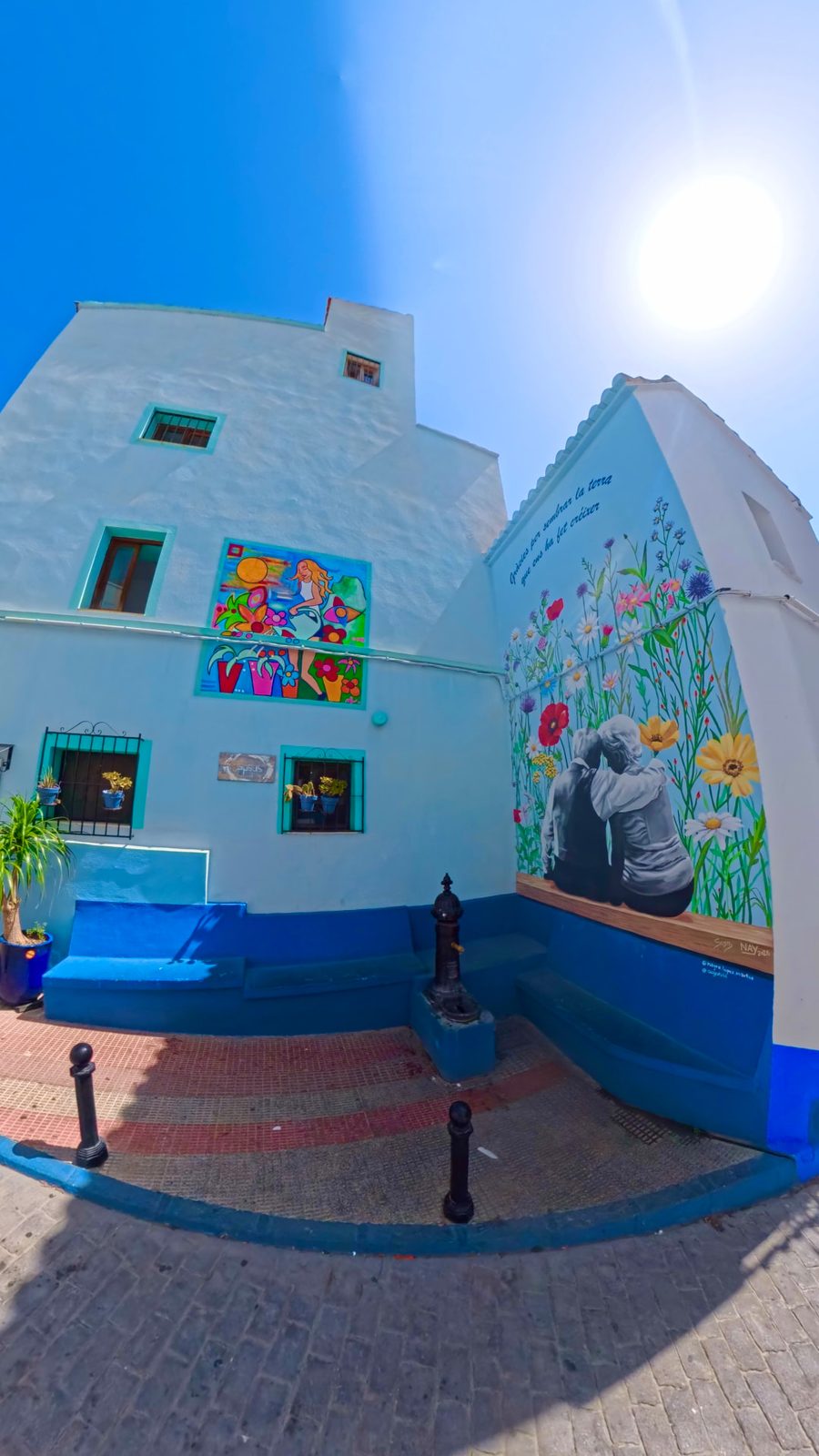 A painted mural and blue-washed houses in the old town of Calpe