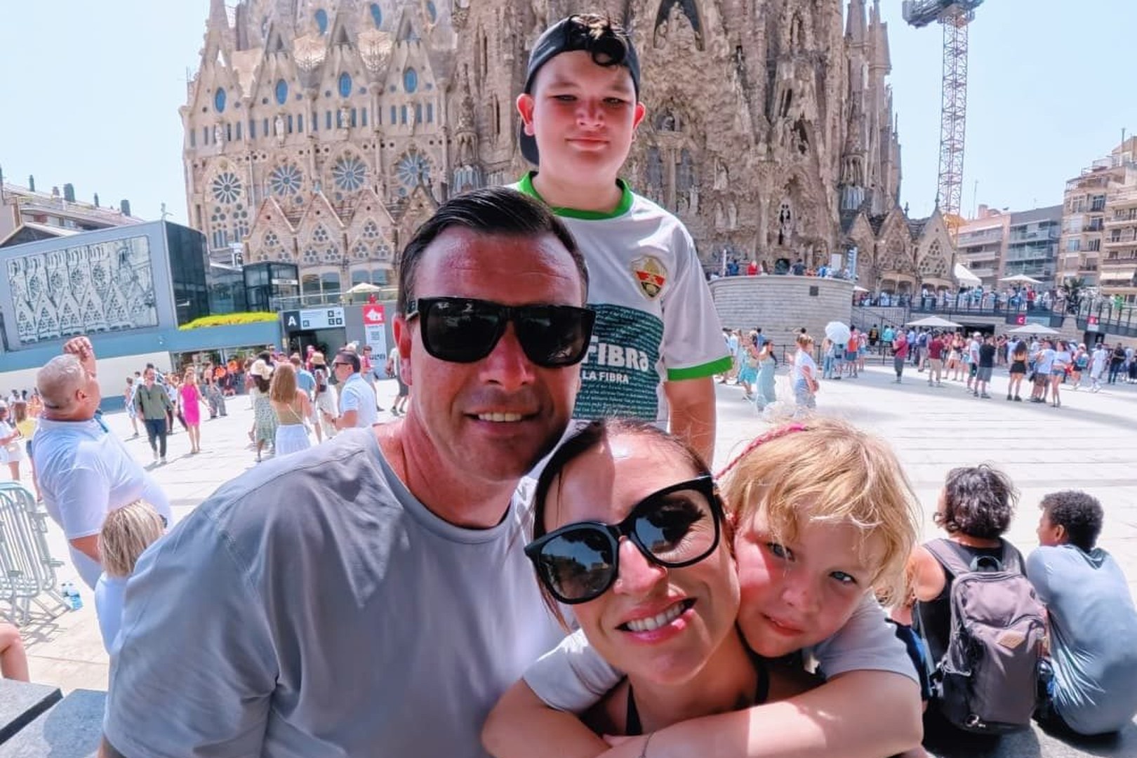 Our family of four in front of the Sagrada Família in Barcelona on a hot summer day