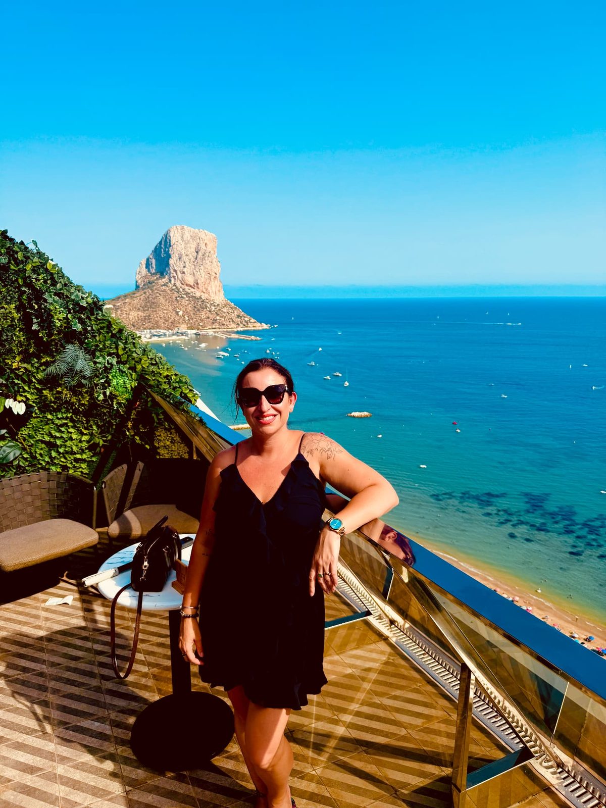 Sylvia on a terrace above Calpe with the Peñón de Ifach and the bay behind