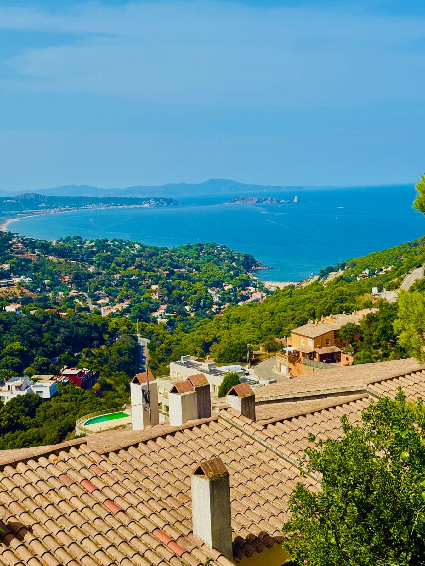 View over pine-covered hills and the bay towards the Medes Islands from above Begur