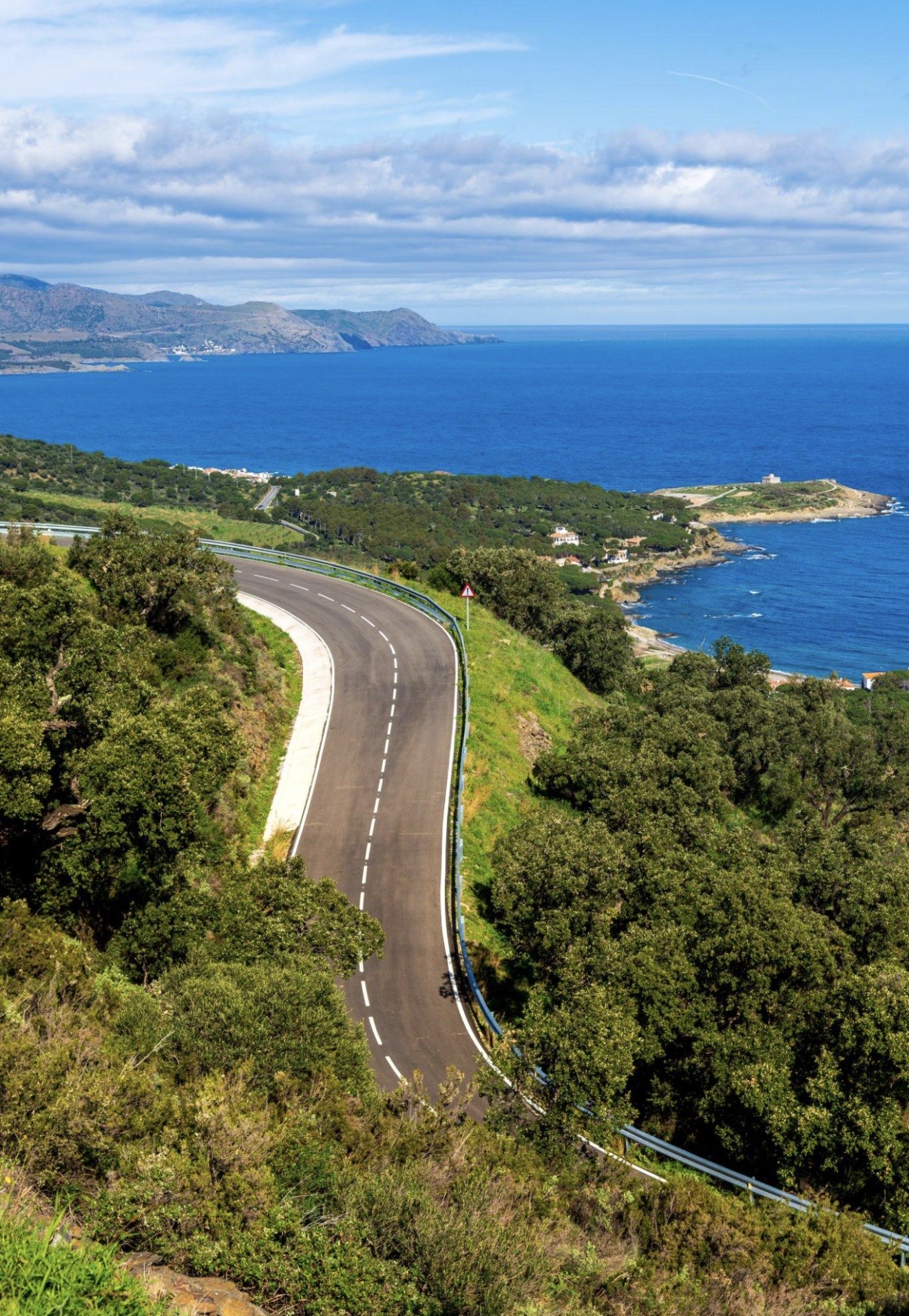 A winding coastal road above the sea and headlands on a Costa Brava road trip